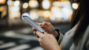 фото: жінка зі смартфоном у руках